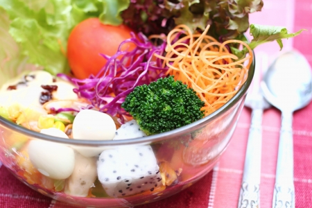 Close up salad in glass bowl with egg, vegetable and fruitの写真素材