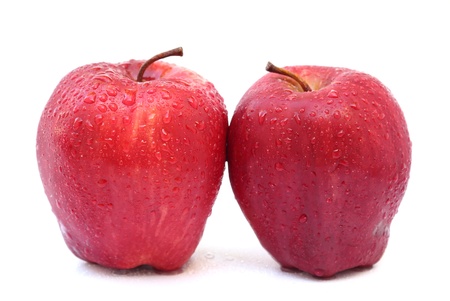 Close up two red apples isolated on white backgroundの写真素材