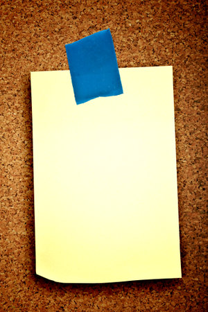 blank sticker glued red ribbon to a cork boardの写真素材