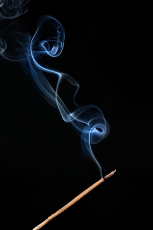 Smoke from incense stick on a black background. Studio shot.の写真素材