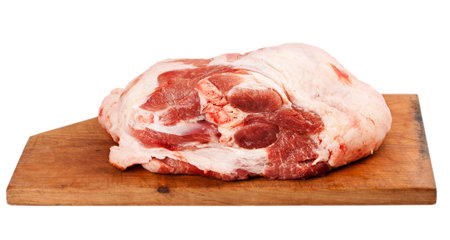 Raw pork meat on a cutting board. Isolated over white backgroundの写真素材