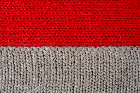 Red and gray knitted fabric as a background, close-upの写真素材