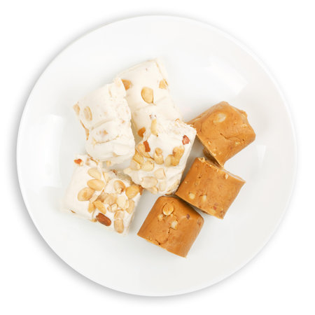 Coffee nougat with nuts on a white background.の写真素材