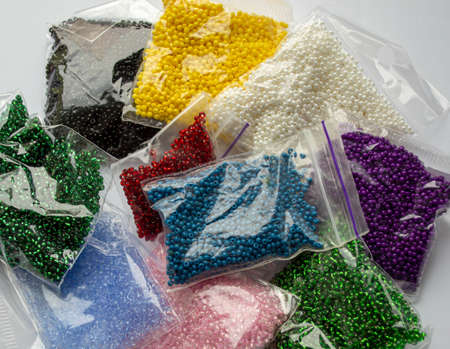 there are many colored beads on a white background