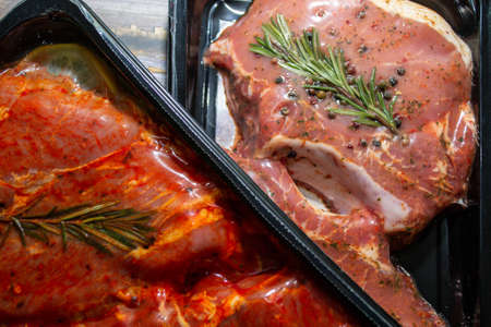 pieces of meat in packing on a wooden backgroundの写真素材