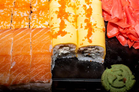 translation on an orange background sushi, rolls, wasabi and gingerの写真素材