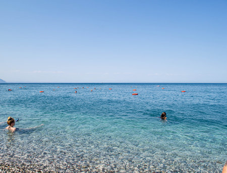 Beach, sea, mountains and sky in Kemer in Turkey. Beach Vacation July 2021のeditorial素材