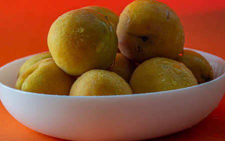 Apricot. Ripe organic apricots on an orange background. Ukraine july 2021