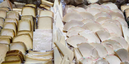 Showcase with cheeses. Lots of different cheeses on display. A variety of cheeses. Ukraine, Kharkiv...