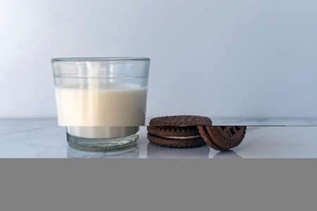 Chocolate chip cookies with milk on a light background. Chocolate sandwich - cookies.