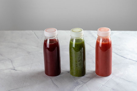 Colorful smoothie, healthy detox, vitamin diet or vegan food concentration. fresh vitamins. Drink with spinach, kiwi, strawberries and cherries.の写真素材