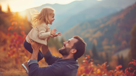 Happy family playing in the autumn park. Man throws up his daughter in the air. The concept of a happy family.の素材