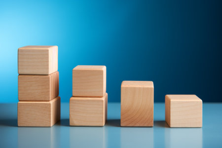 Wooden blocks of different heights on a blue backgroundの素材