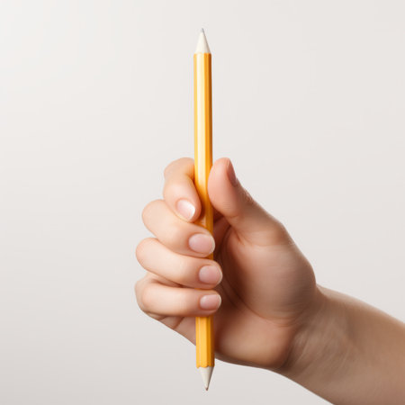 A hand holding a pencilの素材