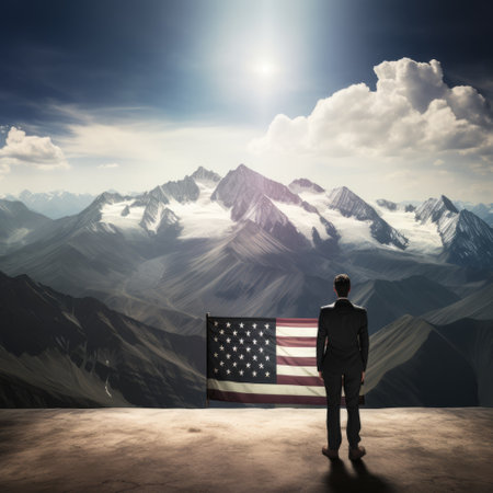 Businessman on top of a mountain holding an American flagの素材