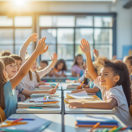 Group of multiracial children raising hands in classroomの素材