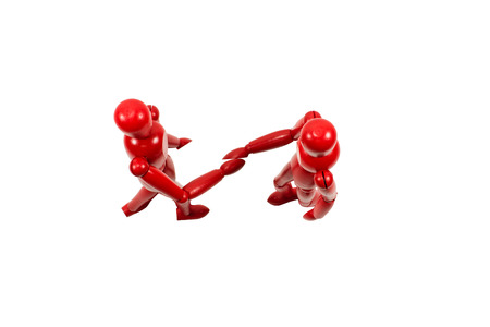 Red wooden art models shaking hands as seen from above