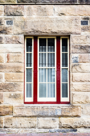 Sandstone block wall with grated windowの写真素材