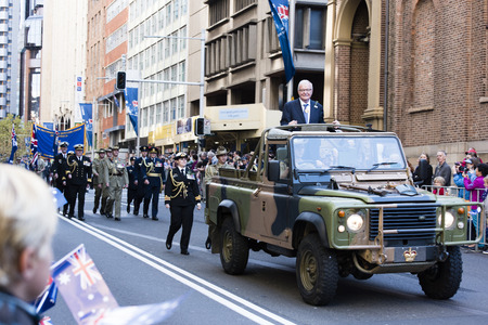 The RSL president smiles at the crowd while standing in the back of an army jeep as they drive down along Elizabethのeditorial素材