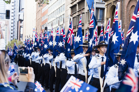 The airforce cadet unit marches by the crowd along Elizabeth St holding their flags highのeditorial素材