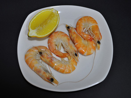Plate of prawns and half a lemonの写真素材