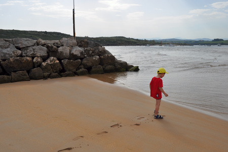 Little boy walking on the beachの写真素材