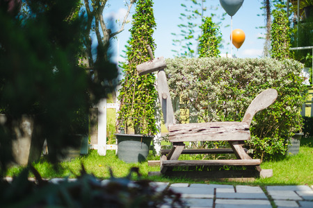 Antique wooden rocking horse in garden.