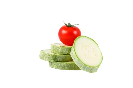 fresh green marrow and tomato isolated over white backgroundの写真素材