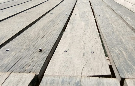 Old wooden floor dilapidated, close up to seam.