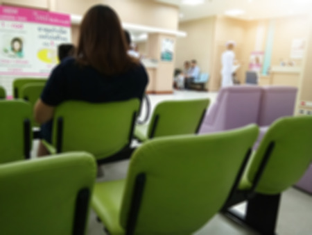 Abstract blur background of hospital or clinic interior waiting hall. 	 Patient people waiting for see doctor in front of out patient department (OPD).の写真素材