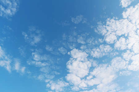Bright blue sky with white clouds on a clear day.