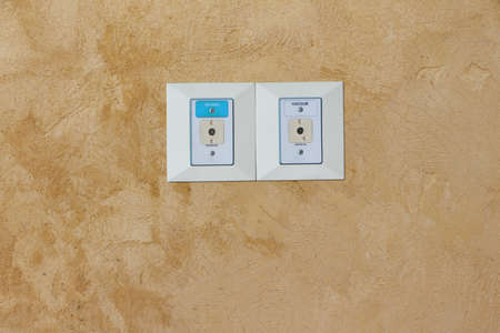 Oxygen and vacuum plug sockets on the old concrete wall in the hospital room.
