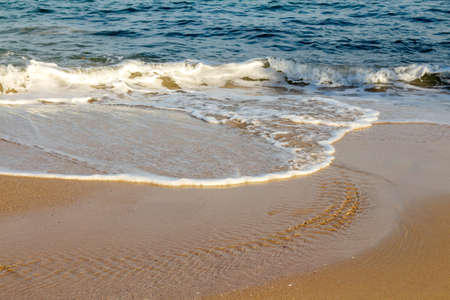 Beautiful white ocean waves on the empty beach.の写真素材