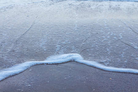 Beautiful white ocean waves on the empty beach.の写真素材