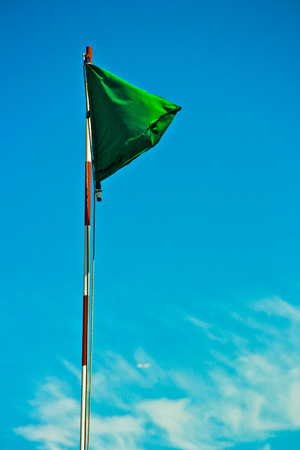 Green Flag in the windの写真素材