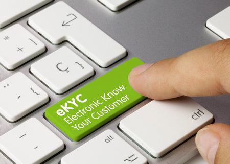 eKYC Electronic Know Your Customer Written on Green Key of Metallic Keyboard. Finger pressing key.