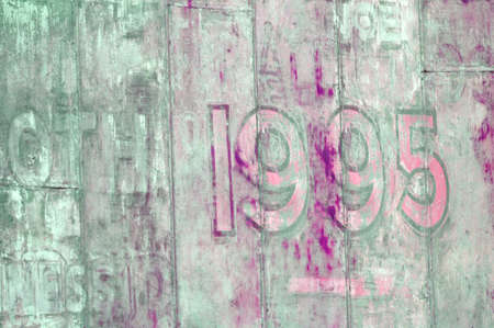 Grungy painted old wall with 1995 date on itの写真素材