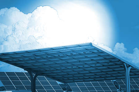 Assortment of solar panels gathering sun for energy with bright blue skyの写真素材