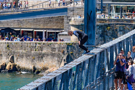 A man jumping down to River Douro from Dom Luis I Bridge in Porto, Portugalのeditorial素材