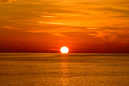 Sunset on the sea with orange clouds