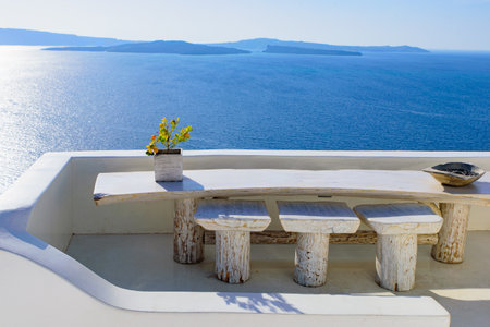 Outdoor seats facing Aegean Sea in Oia, Santorini, Greeceの写真素材