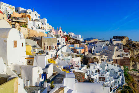 Traditional white buildings facing Aegean Sea in Oia, Santorini island, Greeceの写真素材