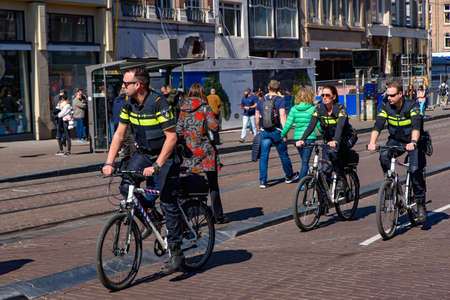 Dutch police officers on bike in Amsterdam, Netherlandsのeditorial素材