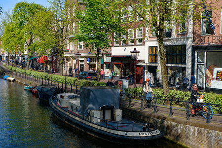 Buildings and boats along the canal in Amsterdam, Netherlandsのeditorial素材