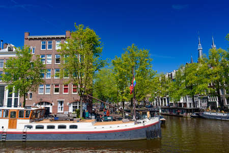 Buildings and boats along the canal in Amsterdam, Netherlandsの写真素材