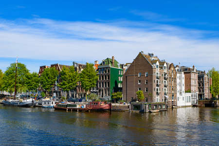Buildings and boats along the canal in Amsterdam, Netherlandsのeditorial素材