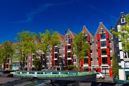 Buildings and boats along the canal in Amsterdam, Netherlandsのeditorial素材