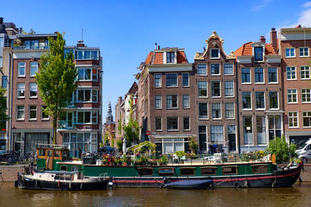 Buildings and boats along the canal in Amsterdam, Netherlandsのeditorial素材