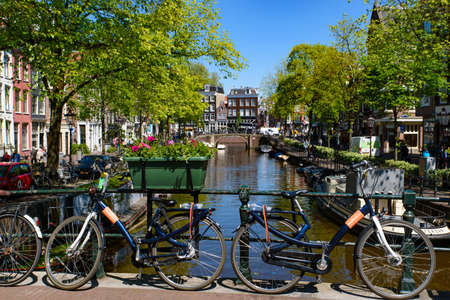 Bikes on the bridge that crosses the canal in Amsterdam, Netherlandsのeditorial素材
