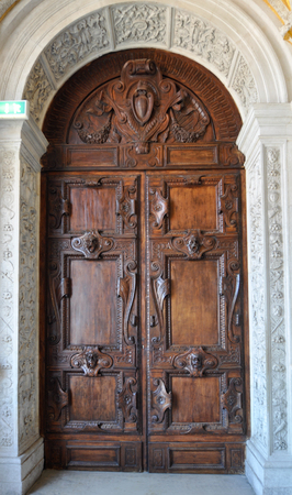 Ornate wooden palace door inside a museum of Venice, Italy.のeditorial素材